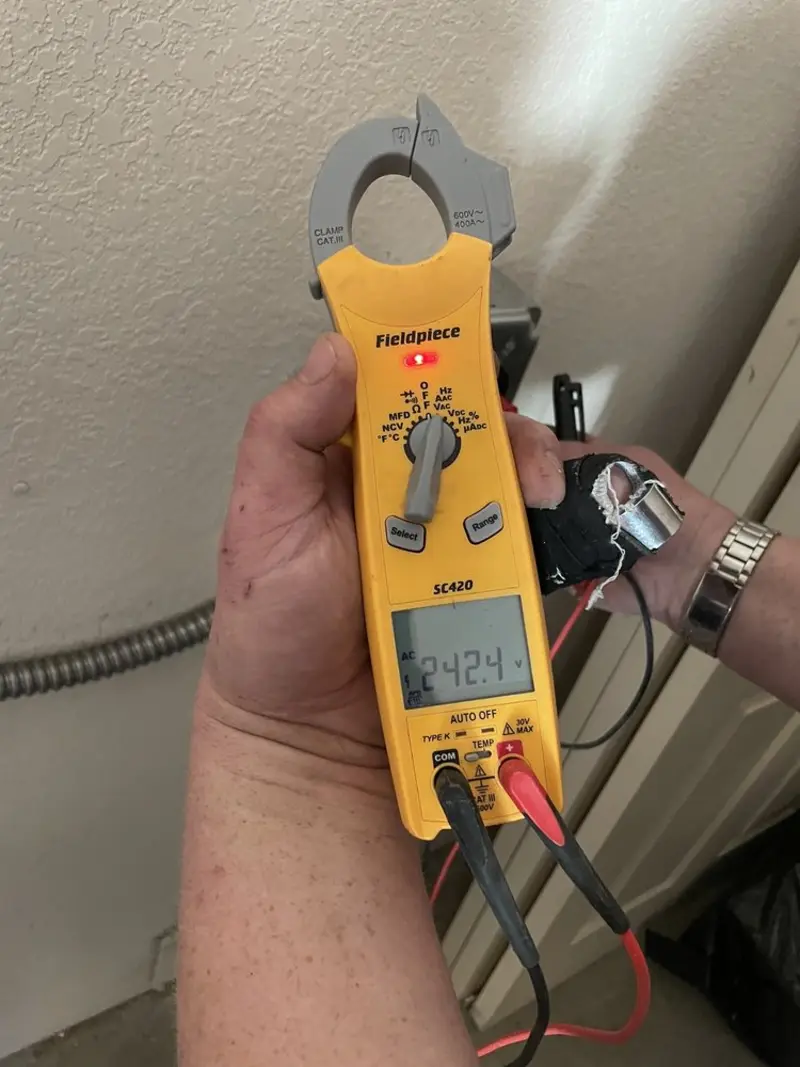 Voltage testing with clamp meter during Recessed Lighting Installation in Rendon